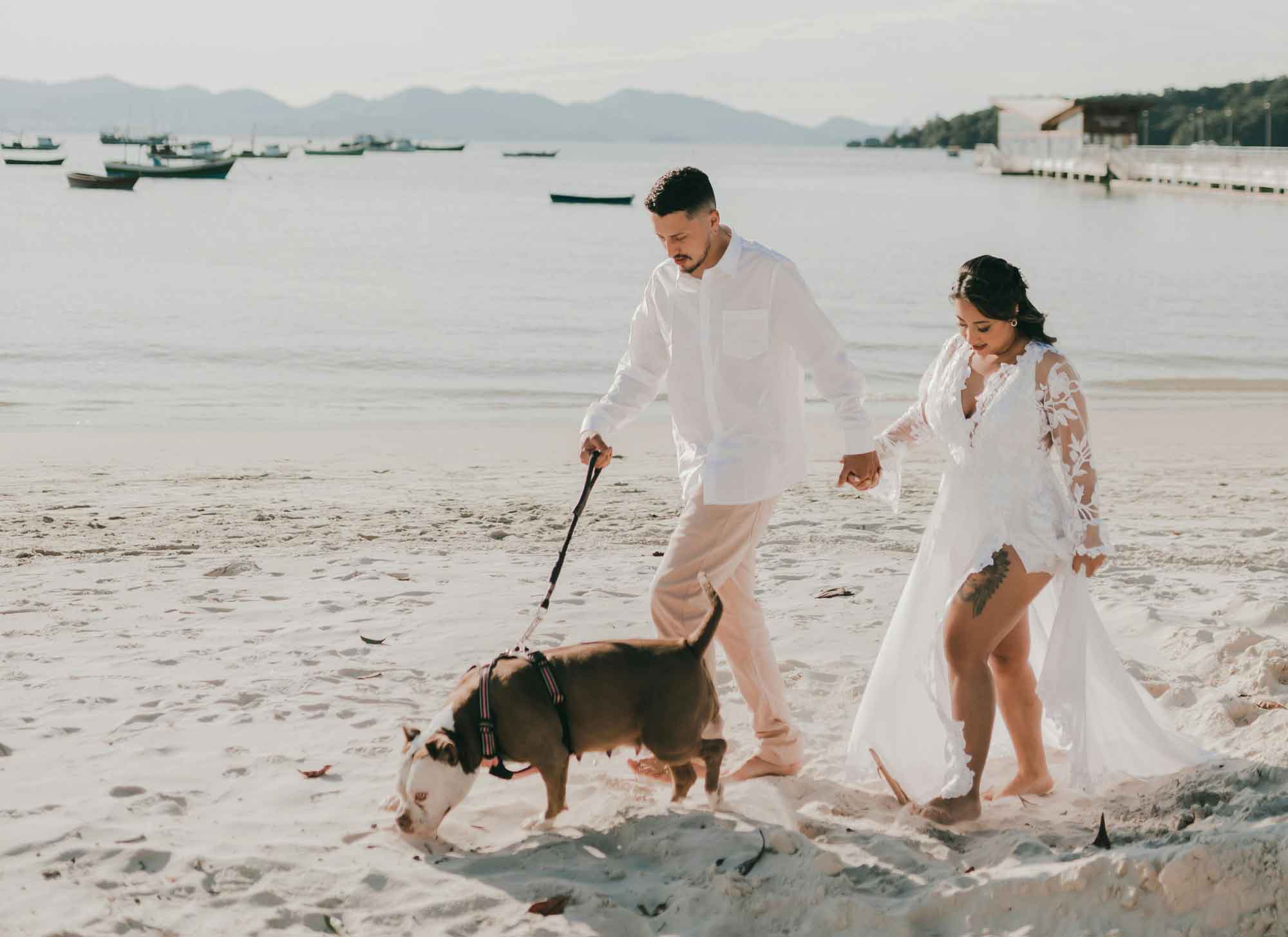 couple engagement photo shoot on beach with their dog