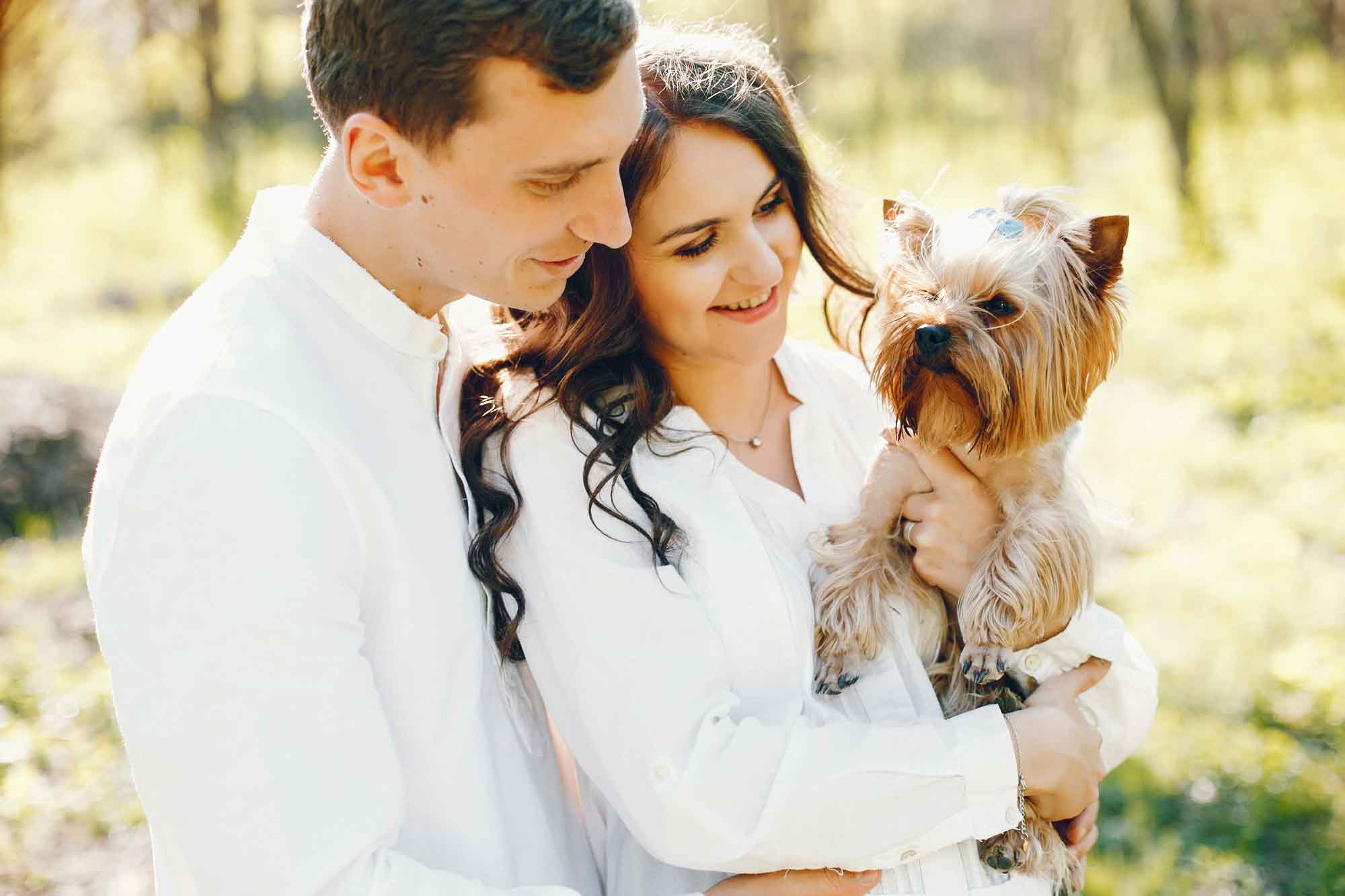 engagement couple photo holding small terrier dog