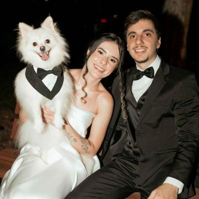 White Dog Wearing Tuxedo With Bride And Groom