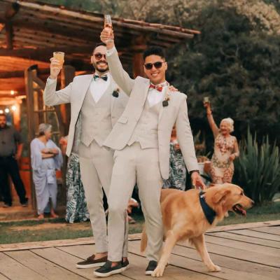 Two Groomsmen Raising Glasses With Dog