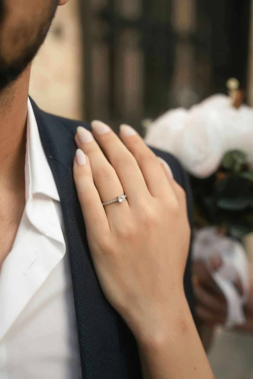 woman engagement ring mans shoulder